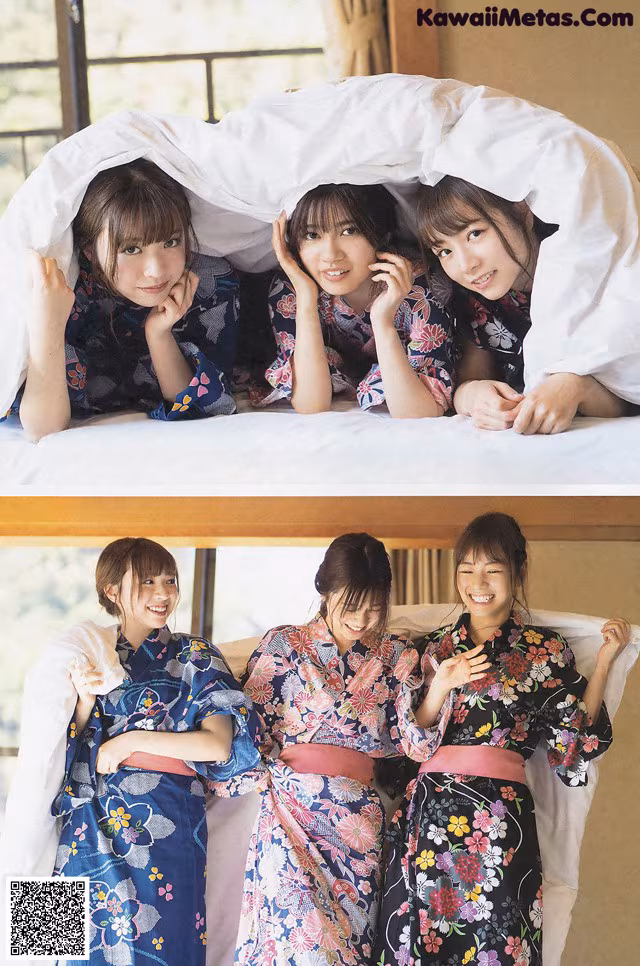 A group of women in kimonos laying on top of a bed.