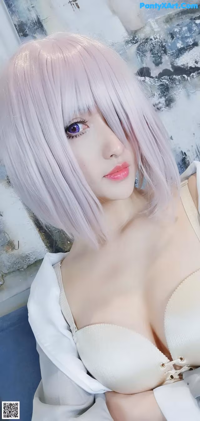 a woman with pink hair and a white shirt