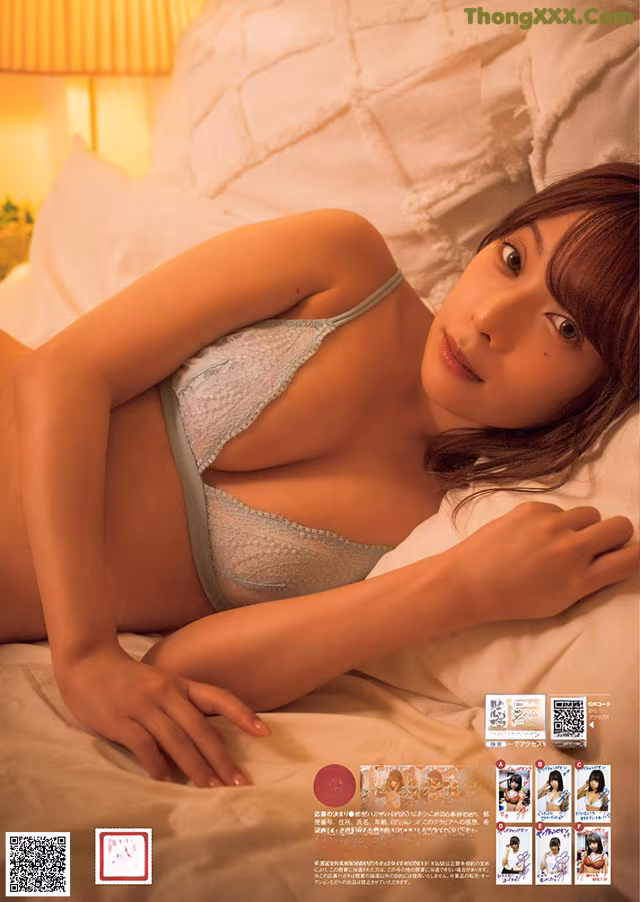 A woman laying on top of a bed in lingerie.