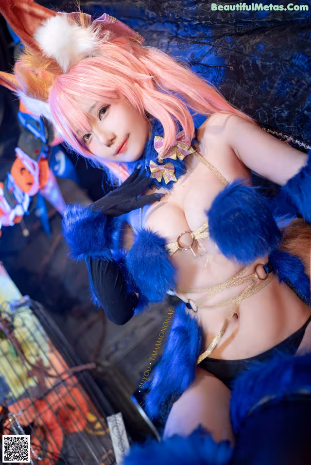 A woman with pink hair wearing a bunny costume.