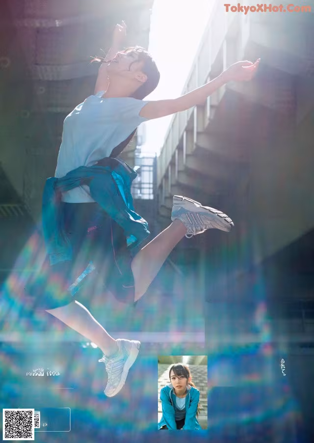 A woman jumping in the air with her arms outstretched.
